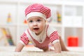 Six months old baby girl crawling on floor in nursery Royalty Free Stock Photo