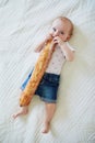Six months old baby girl eating bread Royalty Free Stock Photo