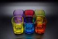 Six multicolored shot glasses on black background Royalty Free Stock Photo