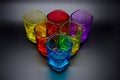 Six multicolored shot glasses placed in triangle on black background Royalty Free Stock Photo