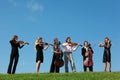 Six musicians play violins against sky Royalty Free Stock Photo