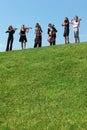 Six musicians play violins against sky Royalty Free Stock Photo