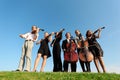 Six musicians play violins against sky Royalty Free Stock Photo