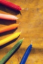 Six natural beeswax candles arranged on wooden table Royalty Free Stock Photo