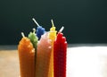 Six natural beeswax candles on dark background Royalty Free Stock Photo