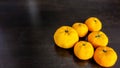 Six oranges on table.
