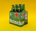 Six pack of Heineken light lager beer over yellow