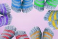 Six pairs of legs in striped socks with toes in colors of LGBT flag form the frame Royalty Free Stock Photo