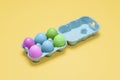 Half dozen dyed easter eggs in egg carton container Royalty Free Stock Photo