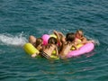 Six people in the crowd on beach toys on sea