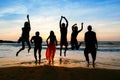 Six people jumping on beach at sunset. Royalty Free Stock Photo