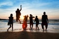 Six people jumping on beach at sunset. Royalty Free Stock Photo