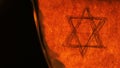 Six Point Star Hexagram Star of David Religion Symbol on Old Paper Burning