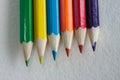 Six colored pencils on a white paper Royalty Free Stock Photo