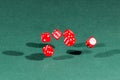 Six red dices falling on a green table Royalty Free Stock Photo