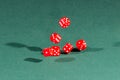 Six red dices falling on a green table Royalty Free Stock Photo