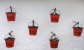 Six Red Fire Buckets hanging on a white textured wall Royalty Free Stock Photo