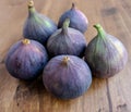 Six ripe figs in a group on a table close-up