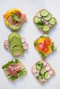 Six sandwich with avocado, radish, cucumber and fresh cheese, healthy summer snack for children and adults, top view Royalty Free Stock Photo
