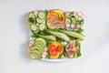 Fresh sandwich with avocado, radish, cucumber, raw ham, pepper and fresh cheese, summer healthy snack Royalty Free Stock Photo