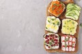 Six sandwiches on toast with fresh carrots, cucumbers, pineapple, red currant, crab sticks and quail eggs with peas microgreens on