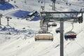 Six-seat ÃÂhairlift lifts mountain skier family on hill in Tyrol Alps