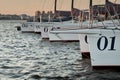 six sheathed sailboats stand in port waiting for tomorrow's race, bowsprits and masts at dusk Royalty Free Stock Photo