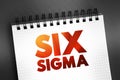 Six Sigma - set of techniques and tools for process improvement, text concept on notepad