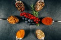 Silver spoons with various spices arranged on a slate and fruit in the middle Royalty Free Stock Photo