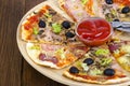 Six slices of pizza with different toppings on wooden board Royalty Free Stock Photo