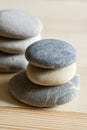 Six spa zen stones stacked on a wood background Royalty Free Stock Photo