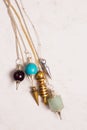 Six stone pendulums for balancing chakras Royalty Free Stock Photo