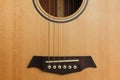 six-string acoustic guitar on a red background