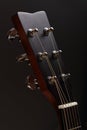 Six-stringed acoustic guitar head with tuning pegs close-up Royalty Free Stock Photo