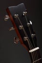 Six-stringed wooden acoustic guitar head with tuning pegs Royalty Free Stock Photo