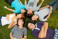 Six teenage friends lying on the grass