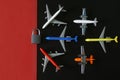 Six toy planes next to a padlock on a black and red background. Concept of sanctions and embargo on air flights and no-fly zone.