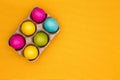 Six vivid colored Easter eggs in a carton Royalty Free Stock Photo