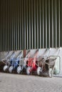 Six wheelbarrows rest against wall of farm barn Royalty Free Stock Photo