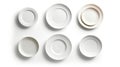 Six white ceramic plates of different sizes arranged on a white background Royalty Free Stock Photo