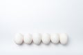 Six white chicken eggs in a row Royalty Free Stock Photo
