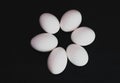 Six white eggs on black background, cenital plane Royalty Free Stock Photo