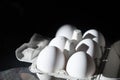 Six white fresh eggs in grey paper container. High contrast picture. Rembrandt natural sunlight. Healthy protein eating Royalty Free Stock Photo