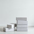 Six white rectangular blocks are stacked against a plain, light-colored wall. Four blocks Royalty Free Stock Photo