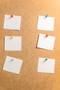 Six white stickers for taking notes on a cardboard background