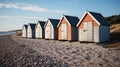 Six wooden huts on a beach on a sunny day