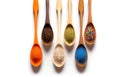 six wooden spoons full of different color sand and seeds