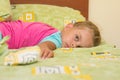 Six-year girl lying across bed, trying to sleep