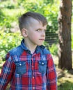 Six-year-old boy looks askance at the lens in the garden Royalty Free Stock Photo