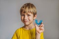 Six-year old boy shows myofunctional trainer. Helps equalize the growing teeth and correct bite, develop mouth breathing Royalty Free Stock Photo